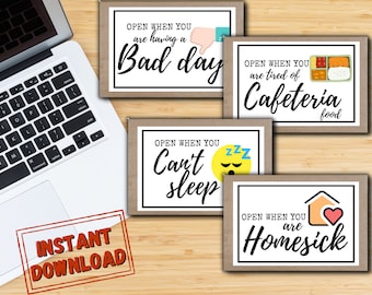 May include: Set of four printable cards with brown paper borders and white backgrounds. Each card has a different message and image. The first card says "Open when you are having a bad day" and has a thumbs down emoji. The second card says "Open when you are tired of cafeteria food" and has a cartoon image of a lunchbox. The third card says "Open when you can't sleep" and has a cartoon image of a sleeping face. The fourth card says "Open when you are homesick" and has a cartoon image of a house with a heart.