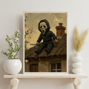 May include: Framed artwork featuring a child in a Scream mask and black jumpsuit, holding a knife, sitting on a rooftop. The painting has a vintage, slightly blurred aesthetic with a muted color palette, evoking a sense of suspense and horror.
