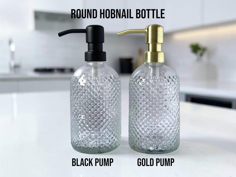 May include: Two round hobnail bottles with clear glass bodies and pump dispensers. One bottle features a matte black pump, while the other has a brushed gold pump. The text ROUND HOBNAIL BOTTLE, BLACK PUMP, and GOLD PUMP is visible in the image.