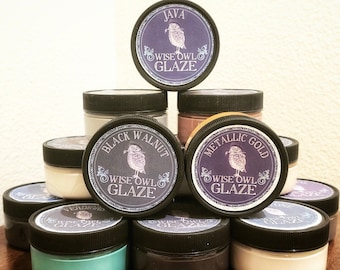 May include: A collection of 10 glass jars with black lids and labels. The labels feature an owl design and the text "Wise Owl Glaze". The jars are labeled with different colors, including Java, Black Walnut, Metallic Gold, Verdigris, and more.