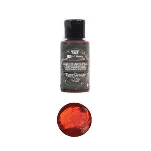 May include: A bottle of Art Alchemy Liquid Acrylic in Tiger Orange, 1 fl oz (30 ml). The label includes the product name in English, French, and Spanish. A swatch of the orange paint is shown below the bottle.