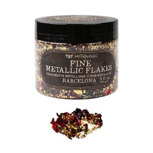 May include: A clear plastic jar with a black lid containing fine metallic flakes in gold, red, and dark tones. The label reads Art Ingredients Fine Metallic Flakes Barcelona 5 fl. oz. A small pile of the same gold and red flakes sits below the jar.