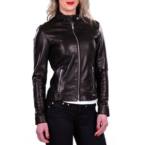 Puede incluir: Una chaqueta de cuero negra con cierre de cremallera y cuello alto.