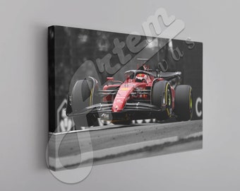 May include: A red Formula 1 race car speeding on a black and white racetrack. The car is in focus, while the background is blurred.