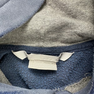 May include: A blue and gray hooded sweatshirt with a white tag that reads "M" and "Made in Indonesia" with a size tag that reads "M".