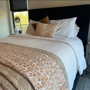 Blossoming Elegance: Exquisite Floral Embroidery on a Pristine White Quilt