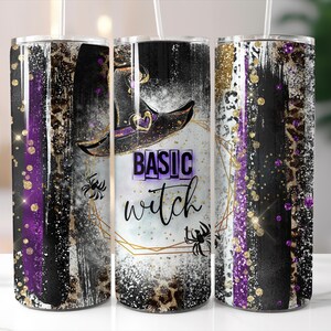 May include: A stainless steel tumbler with a witch-themed design. The tumbler features a black witch hat, spiders, and the words "BASIC witch" in a purple and black color scheme. The design includes gold glitter accents.