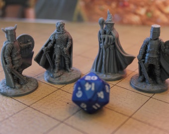 May include: A collection of gray miniature fantasy figures, including knights and a wizard, are arranged on a grid. A blue, multi-sided die with white numbers sits in the foreground. The figures are detailed and appear to be 3D-printed.