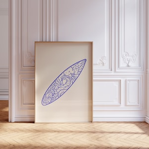 May include: A framed print of a blue line drawing of a surfboard with a wave and nature scene design.