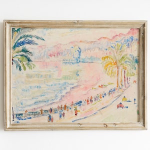 May include: Watercolor painting of a beach scene with palm trees, people, and buildings. The artwork features a pastel color palette with pink, blue, and yellow hues. The painting is framed in a gold-colored wooden frame.