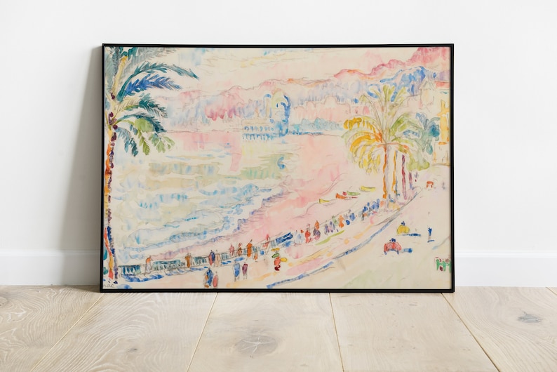 May include: Watercolor painting of a beach scene with palm trees, people, and buildings. The artwork features a black frame and is displayed on a light wood floor. The color palette includes pink, blue, green, and yellow.