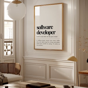 May include: A black and white printable wall art print with a definition of a software developer. The definition reads: "a caffeine fuelled wizard who turns coffee into code, fights bugs for a living, and makes stuff work - usually by saying, 'It works on my machine.'"