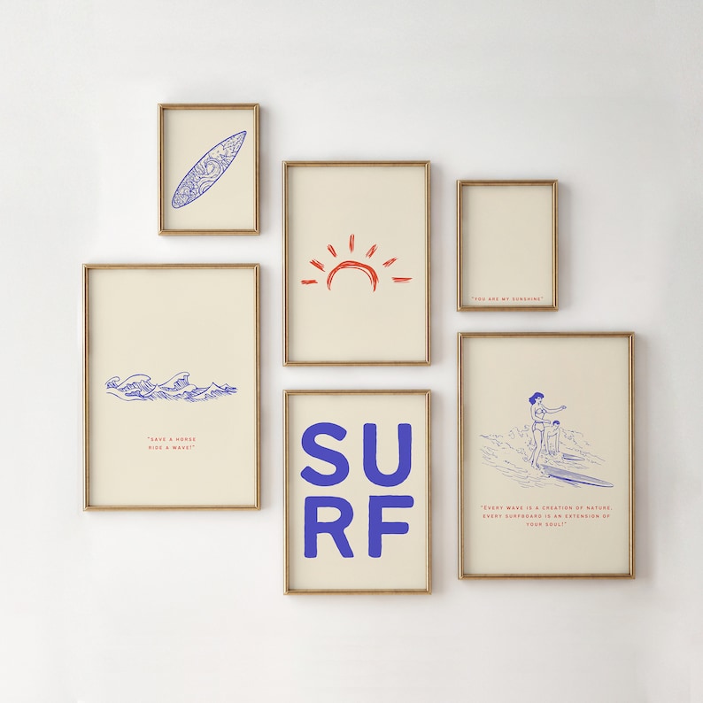 May include: A set of six framed prints with a beach theme. The prints feature a surfboard, a sun, waves, the word "SURF" in blue, and two quotes about the ocean. The prints are all in gold frames and have a cream background.