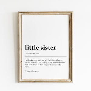May include: A framed print with a white background and black text that reads "little sister [lit-tle sis-ter] noun i will pick you up when you fall. I will forever be your partner in crime. I will stick up for you when no one else will. I will always be there for you when you need a friend. "a sister is forever."