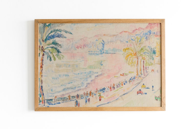 May include: A framed print of a beach scene with palm trees, people, and buildings. The artwork features a pastel color palette of pink, blue, yellow, and green. The frame is made of light-colored wood.
