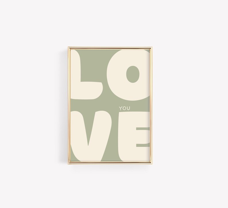 May include: A framed print with a sage green background and white text that reads "LOVE YOU" in a stylised font.