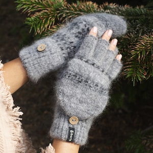 May include: Grey fingerless gloves with a fold-over mitten cuff. The gloves have a textured knit pattern and a wooden button on each cuff. The brand name "Siberia" is printed on the cuff.