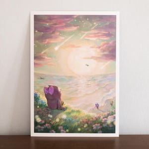 Könnte beinhalten: Ein rechteckiger Kunstdruck, der ein braunes Wesen mit einer rosa Schleife zeigt, das auf einem grasbewachsenen Hügel sitzt und auf ein Meer unter einem Sonnenuntergangshimmel blickt. Der Himmel zeigt rosa und violette Wolken und Sternschnuppen.