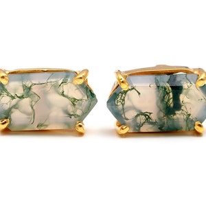 May include: A pair of gold-toned earrings with a light green and white agate stone in a hexagonal shape.