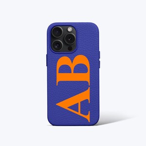 May include: A blue leather phone case with the letters "AB" in orange.