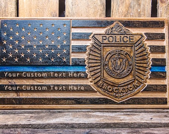 May include: A wooden American flag with a blue line, a police badge, and the text "POLICE" and "BROCKTON" on it.
