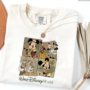 a white shirt with a mickey mouse picture on it