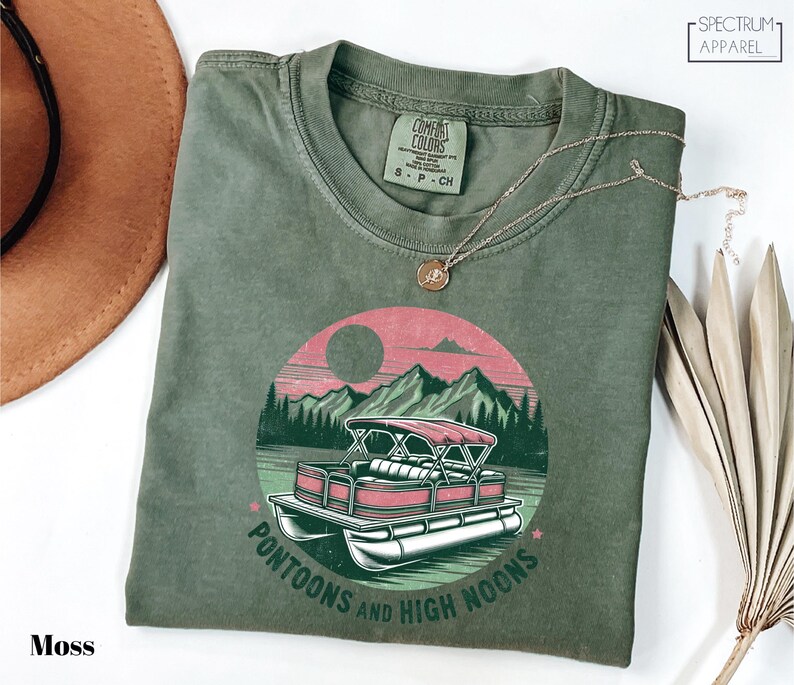 a green t - shirt with a pink car on it