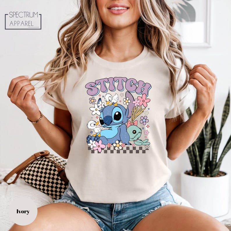 A woman wearing a white t-shirt with a colorful graphic of Stitch from the movie Lilo & Stitch.