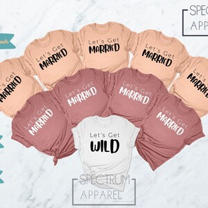 May include: Seven t-shirts in various shades of peach and mauve with the text "Let's Get Married" printed in black. One white t-shirt with the text "Let's Get Wild" printed in black.