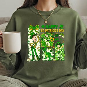 A woman wearing a green sweater with a cartoon character and text related to St. Patrick's Day.