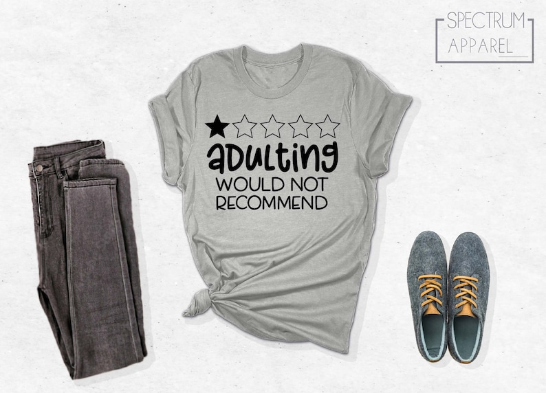 May include: A gray t-shirt with a one-star rating and the text "Adulting Would Not Recommend".