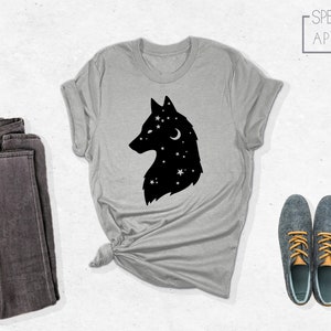 May include: A gray t-shirt with a black silhouette of a wolf's head with stars and a crescent moon inside. The text "SPECTRUM APPAREL" is in the top right corner of the image.