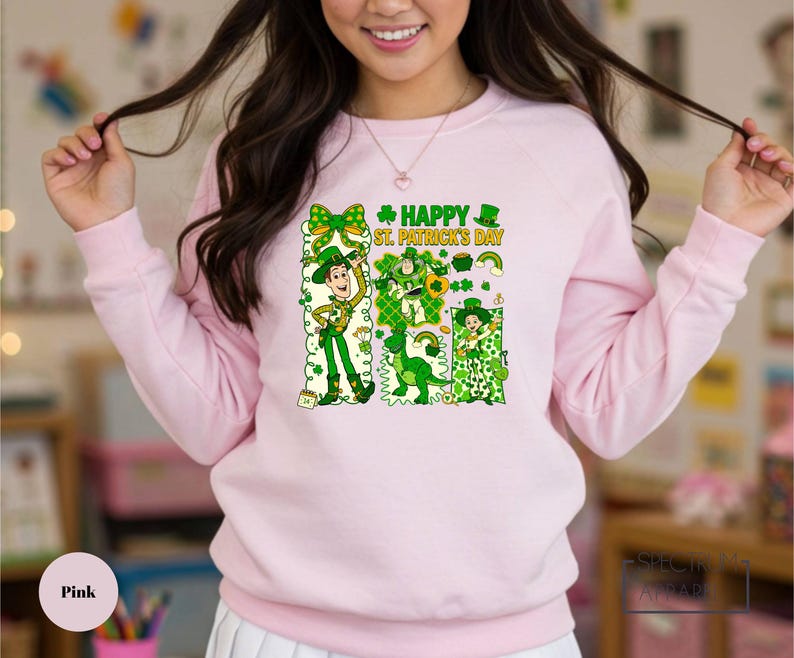 A woman wearing a pink sweatshirt with a cartoon character and text printed on it.