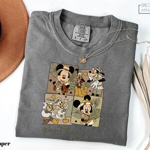 a gray shirt with mickey mouses on it
