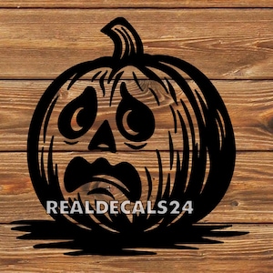 May include: Black pumpkin silhouette with a distressed face design. The pumpkin has a stem and is set against a wooden background. The text "REALDECALS24" is at the bottom of the pumpkin.