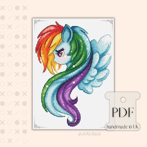 May include: Cross stitch pattern featuring a rainbow-colored pony with a blue, green, purple, and white mane and tail. The pony has a white wing and a pink nose. The pattern is in a white frame with a black border. The text "PDF handmade in UK" is at the bottom of the image.