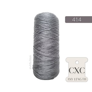 May include: A spool of grey thread with the label "CXC ANY LENGTH" and the number "414" printed on a grey background.