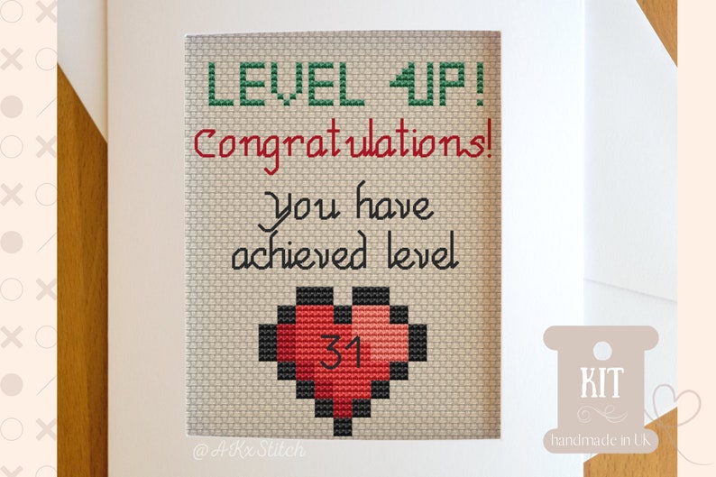 May include: Cross stitch pattern for a card that says "Level Up! Congratulations! You have achieved level 31." The card features a pixelated heart with the number 31 inside.