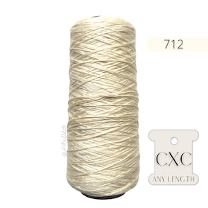 May include: A spool of off-white thread with the text "CXC ANY LENGTH" and the number "712" on a white label.