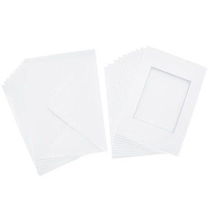 May include: A stack of white cardstock paper with a stack of white photo mats with a window opening.