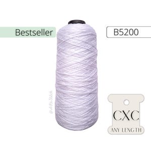 May include: White cotton thread spool labeled "Bestseller" and "B5200". The spool is wrapped in white thread and has a black plastic top. A white tag with the text "CXC ANY LENGTH" is in the lower right corner of the image.