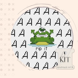 May include: Cross stitch pattern kit featuring a green frog with an angry expression, saying "rip it". The pattern is surrounded by a white background with black letters.