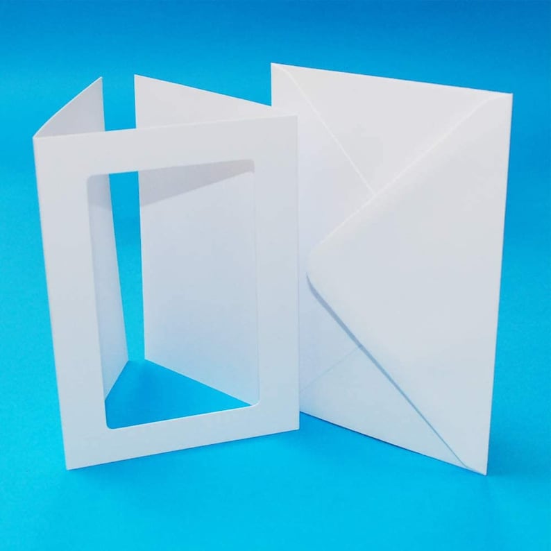 May include: A white card with a window cut out of the front and a white envelope.