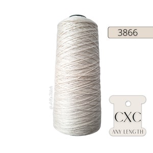 May include: A spool of beige thread with the number 3866 and the text "CXC ANY LENGTH" on a white label.