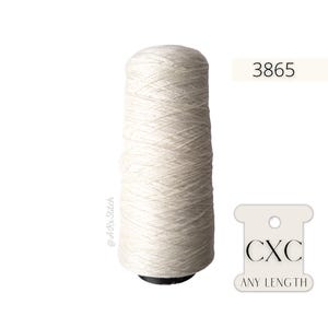 May include: A spool of white yarn with the number 3865 printed on a white label. The yarn is labelled with "CXC ANY LENGTH" on a white tag.