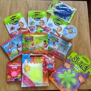 May include: A selection of slime and sensory toys, including neon fluffy slime, bouncing putty, crackle baff, snow play, magical mouldable sand, super sticky slime, and glow in the dark slime. The packaging features bright colours and fun graphics.