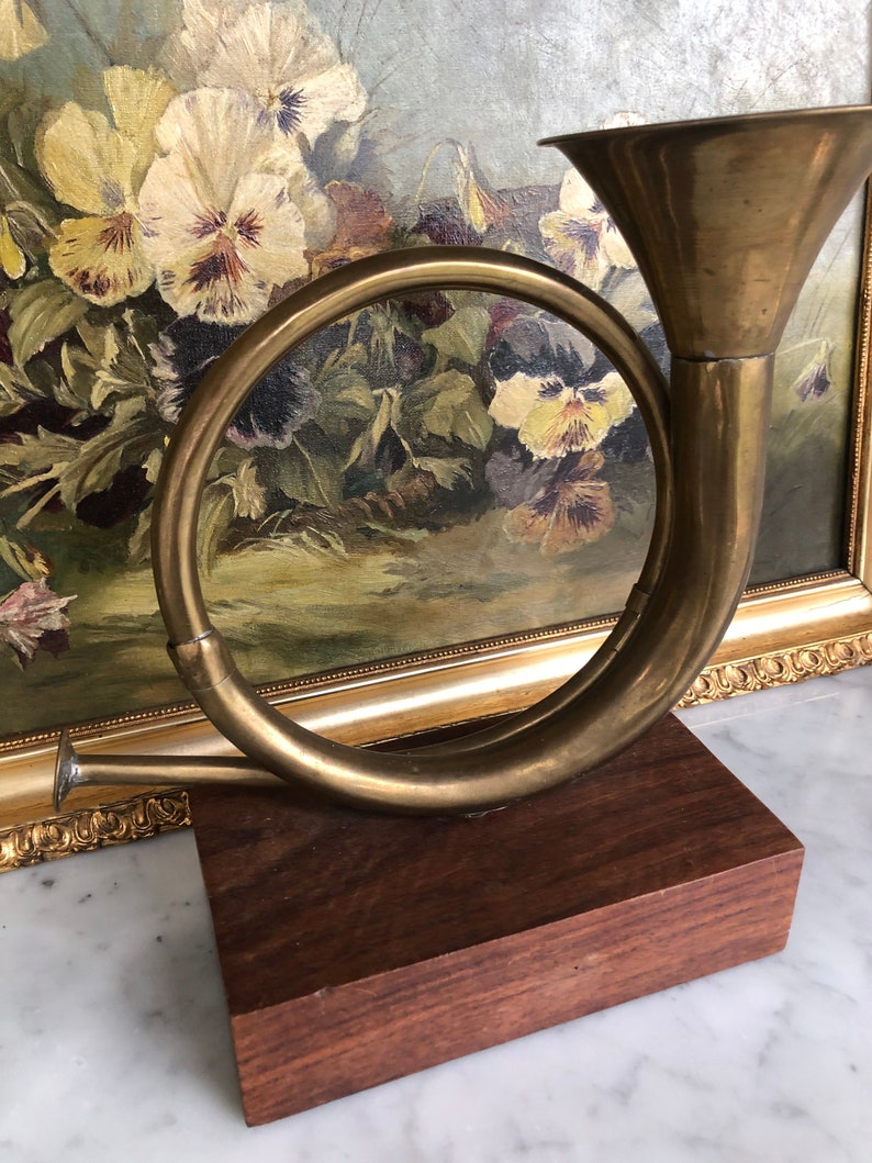 Vintage brass French horn on wood stand decor piece
