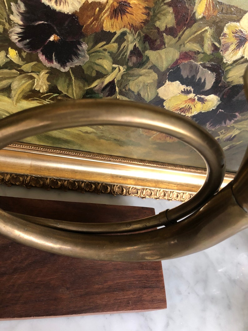 Vintage brass French horn on wood stand decor piece