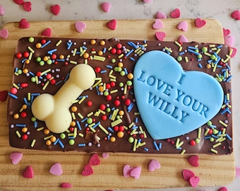 May include: A chocolate bar with colourful sprinkles, a white chocolate bone, and a blue heart with the text "I Love Your Willy".