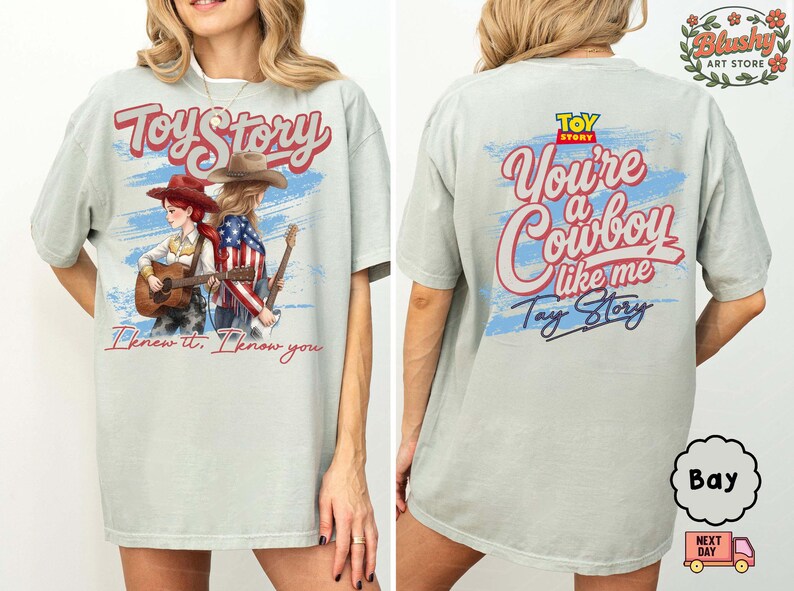 May include: A light gray t-shirt featuring a front graphic of two figures with guitars and the text Toy Story and I knew it, I know you. The back graphic displays the Toy Story logo, the text You're a Cowboy like me, and Toy Story.